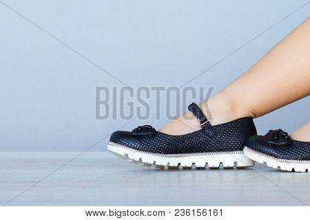 Black Shoes On The Legs Of A Litle Girl