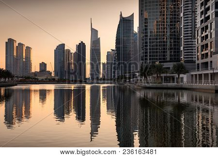 Dusk Skyline Of Jumeirah Lakes Towers With Clear Reflections, Dubai, United Arab Emirates