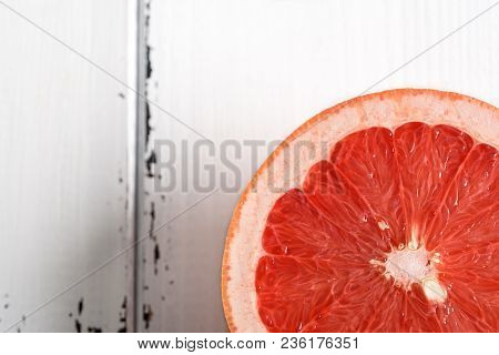 Half Pink Grapefruit On White Wooden Background