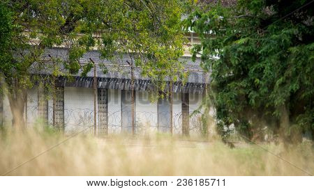 Restricted Area In Military Base Camp Stockaded By Barbed Wire And Steel Fencing Wire Surrounded Wit