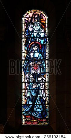 PARIS, FRANCE - JANUARY 08, 2018: Scenes from the life of the Saint Margaret Mary Alacoque, stained glass window in Basilica of the Sacre Coeur, dedicated to the Sacred Heart of Jesus in Paris.