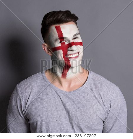 Portrait Of Happy Man With The Flag Of England Painted On His Face. Football Or Soccer Team Fan, Spo
