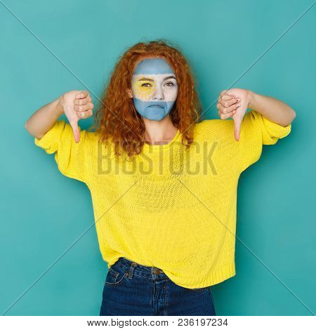 Portrait Of Sad Woman With The Flag Of Argentina Painted On Her Face. Football Or Soccer Team Fan, S
