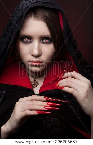 Vintage Style Portrait Of Young Beautiful Vampire Woman With Gothic Halloween Makeup. Manicured Red 