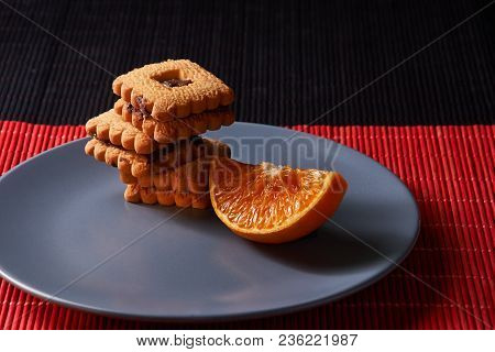 Group Of Chocolate Halloween Cookies On Plate And Red And Black