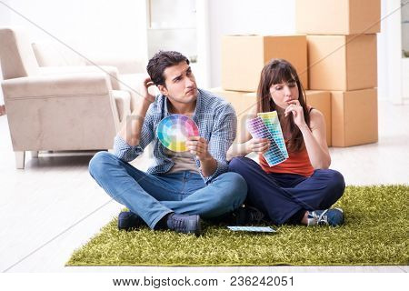 Young family choosiing colours for new apartment