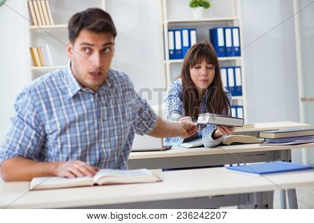 Students sitting and studying in classroom college