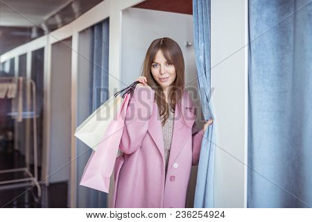 Attrractive girl with shopping bags indoors