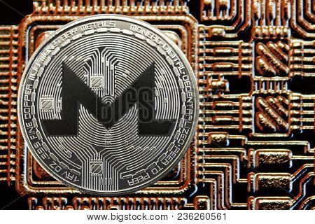 Silver Coin Cryptocurrency Monero On A Background Of Gold Circuit. Xmr Currency.