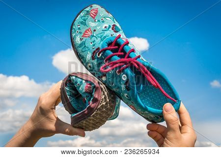 Woman Is Holding Barefoot Shoes With Flexible Sole