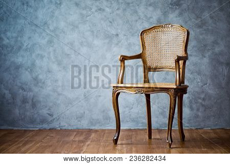 Old Chair On A Gray Wall Background