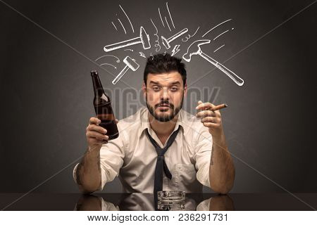 Young drunk disappointed man with hangover concept