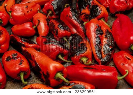 Several Red Peppers Roasting On The Stove To Be Turned Into Ajvar, A Tasty Spread Popular In The Bal