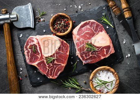 Raw Beef Steak Osso Bucco On Black Stone Slate Background. Marble Meat. Top View.