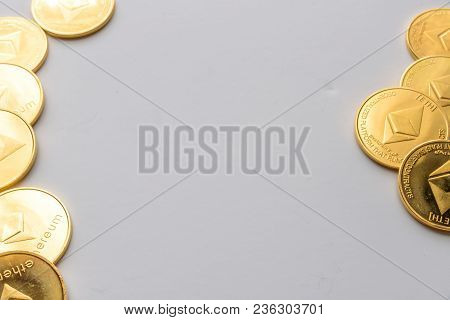Golden Virtual Money Ethereum Crypto Currency Coins Stacked On Bright Background.