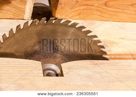 Circular Saw Blade For Cutting Wood Made Of High Speed Steel Mounted On An Old Table Saw With Wooden