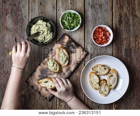 Sandwich With Goat Cheese, Sun-dried Tomatoes And Thyme, Served On The Board At A Bright Wooden Surf