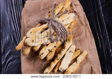 Crispy Grisini With Olive On Old Brown Paper In Studio