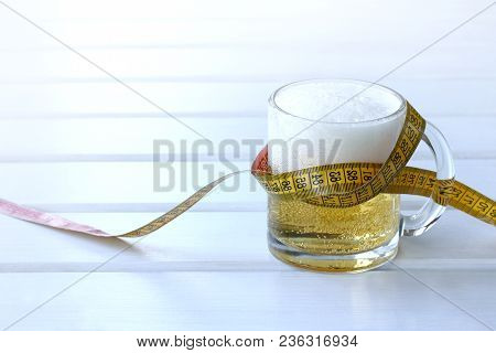 Glass Of Frothy Drink Wrapped Flexible Ruler / Problem Of Excess Weight When Drinking Excessively