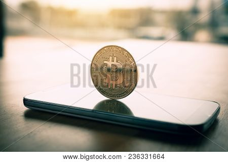Bitcoin Symbol On Smartphone Screen And Cryptography Concept.