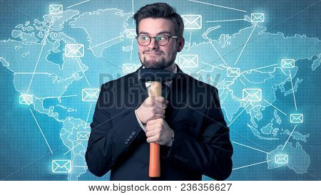 Businessman holding tool with global map graphic on the background