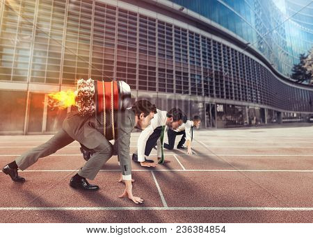 Businessman With Rocket On His Back Ready To Start A Race On Track