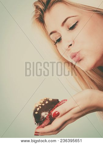 Diet, Sweets, Food Concept. Woman Holding Delicious Chocolate Cupcake With Peanut Frosting About To 