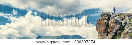 Tourist On Demerdji Mountain In Crimea, Russia. Woman Traveler On Top Of A Mountain On The Clouds Ba
