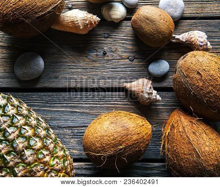 Composition Of Fresh Pineapple And Coconuts On Wooden Background