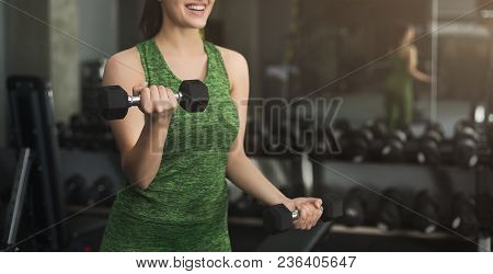 Fitness Woman With Dumbbells Standing At Gym. Unrecognizable Girl Have Intensive Training, Holding S