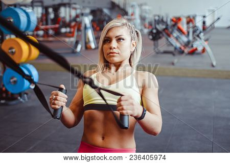 Beautiful Woman Is Doing Exercises In The Sport Club.