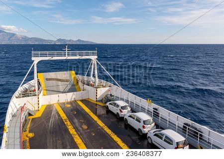 White Cars Parked On Open Car Deck Of Ferry. Ionian Sea. Greece