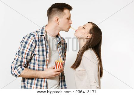 Young Couple In Love, Man, Woman In Casual Clothes Eating Together French Fries Potatoes Isolated On