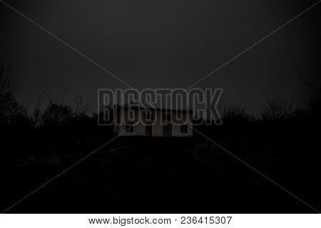 Old House With A Ghost In The Forest At Night Or Abandoned Haunted Horror House In Fog. Old Mystic B
