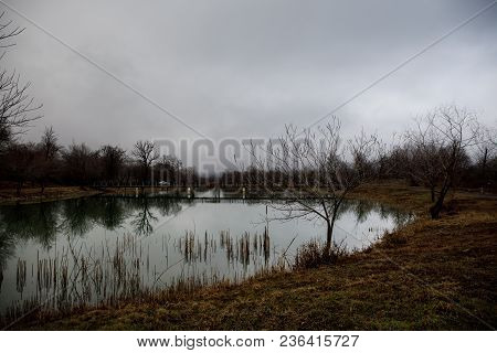Amazing Landscape Of Bridge Reflect On Surface Water Of Lake, Fog Evaporate From Pond Make Romantic
