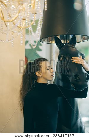 Girl Looks Sexi, Fashionable Indoors. Sexy Girl Standing In Modern Interior. Woman With Natural Make