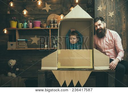 Rocket Launch Concept. Kid Happy Sit In Cardboard Hand Made Rocket. Boy Play With Dad, Father, Littl