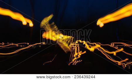 Blurred Lighhts From City Lantern, Car Headlights And Garlands Of Advertising Signs