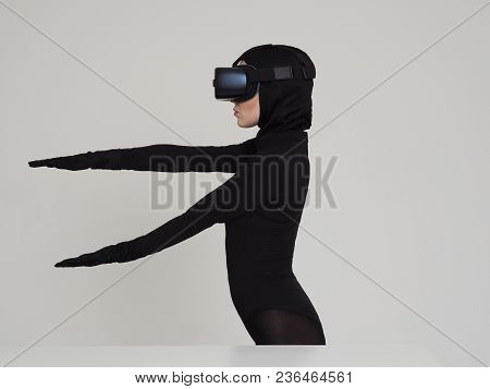 Vr Posing And Showing Off Of A Woman In Black Suit. Experiencing The Virtual Reality Helmet. Hi-tech