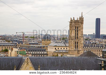 Aerial Street View Of Paris From Above With A Notre Dame Tower Heading Above The City.