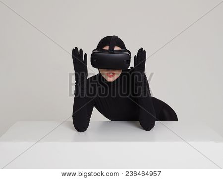 A Girl In A Black Suit Wears Vr Headset To Experience The New Technoligies Of Vitrual Reality. Hi-te