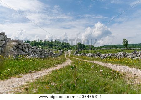 The Rural Road Leads To Small Houses.