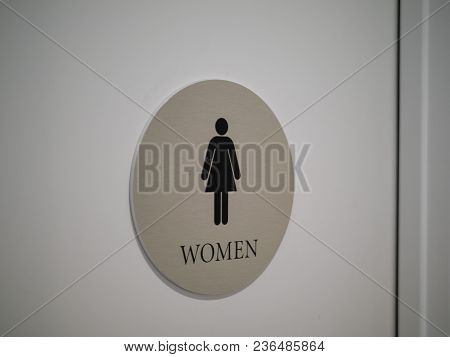 Woman’s Restroom Sign Affixed To Door In Office Building Indoors