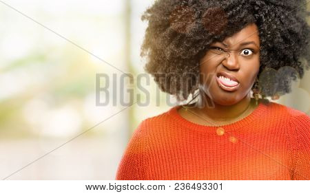 Beautiful african woman making funny face fooling, outdoor