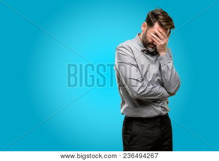Middle age man, with beard and bow tie stressful keeping hands on head, tired and frustrated
