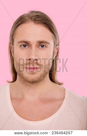 Ruining Stereotype. The Portrait Of A Blue-eyed Bristled Man With A Long Hair Posing For The Camera 