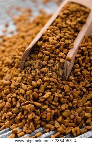 Fragrant Grains Of Fenugreek On A Rustic Background.