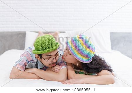 Couple Asian Man And Woman With Woolhat Together Funny Moment On White Bed