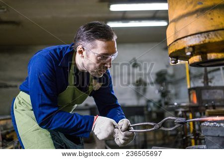 Brutal Man Forges Iron
