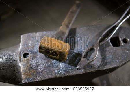 Hammer And Forceps Lie On The Anvil